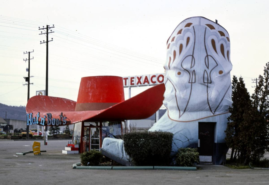 Historic Photo : 1977 Hat n' Boots gas station (1945), boot restrooms with hat behind them view, Route 99, Seattle, Washington | Margolies