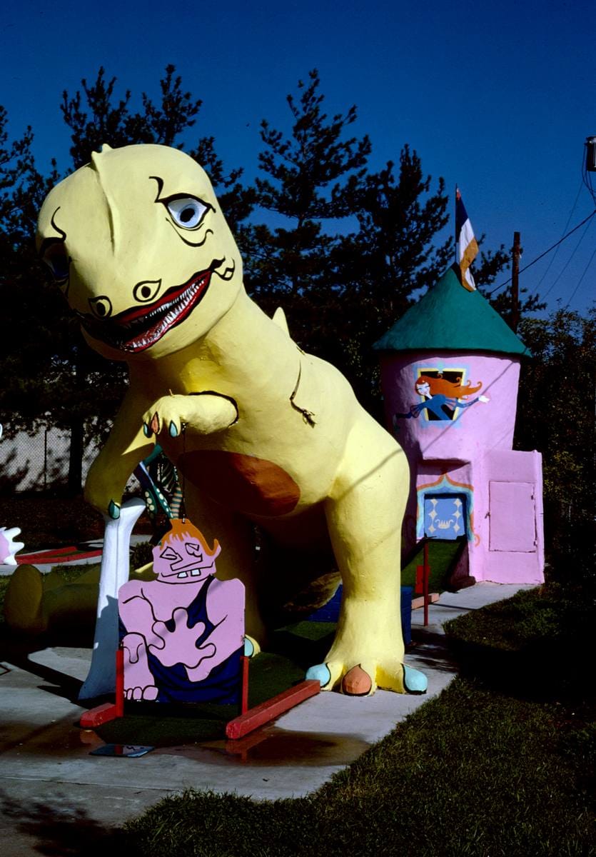 Historic Photo : 1986 Yellow dinosaur and pink castle, Sir Goony Golf, Chattanooga, Tennessee, Chattanooga, Tennessee | Photo by: John Margolies |