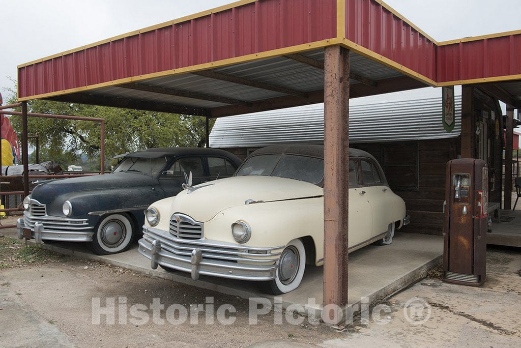 Marble Falls, TX Photo - Old Cars Beneath an Awning at a re-Created Shell Gasoline Station at The Pottery Ranch Pottery Store in Marble Falls, Texas