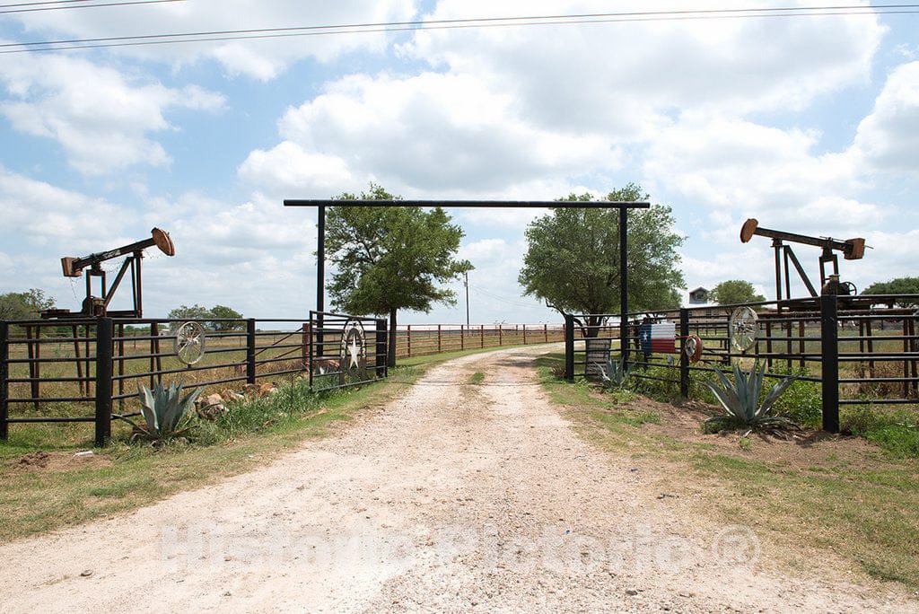 Photo - A Ranch Entrance, dramatically bracketed by Oilfield pumpjacks, in Gonzales County, Texas- Fine Art Photo Reporduction