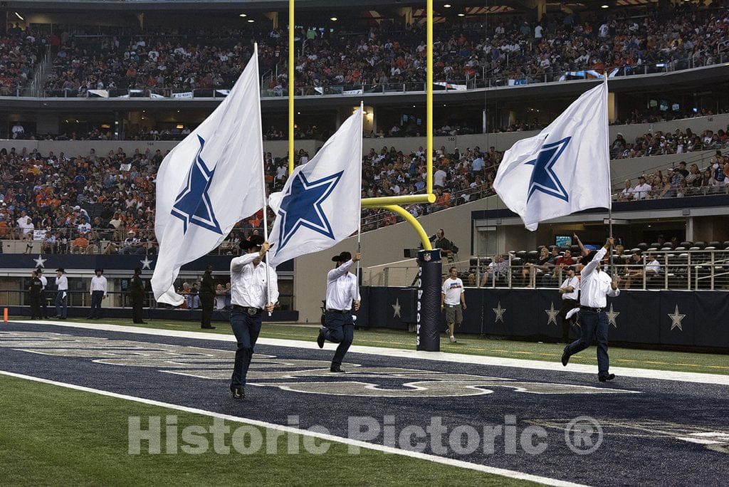 Arlington, TX Photo - Flag-bearers in cowboy hats whip up enthusiasm in the crowd with flags displaying the Dallas Cowboys' emblem at AT&T Stadium in Arlington, Texas.