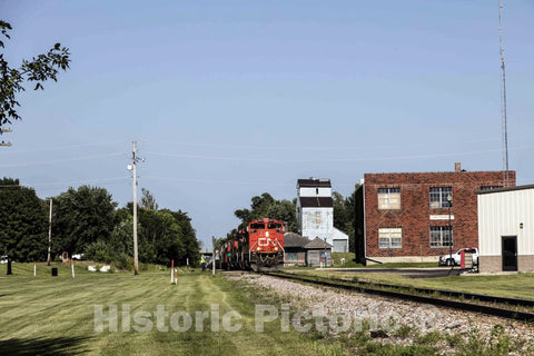 Photo - A diesel locomotive and its long freight train rumble through Ackley, Iowa- Fine Art Photo Reporduction