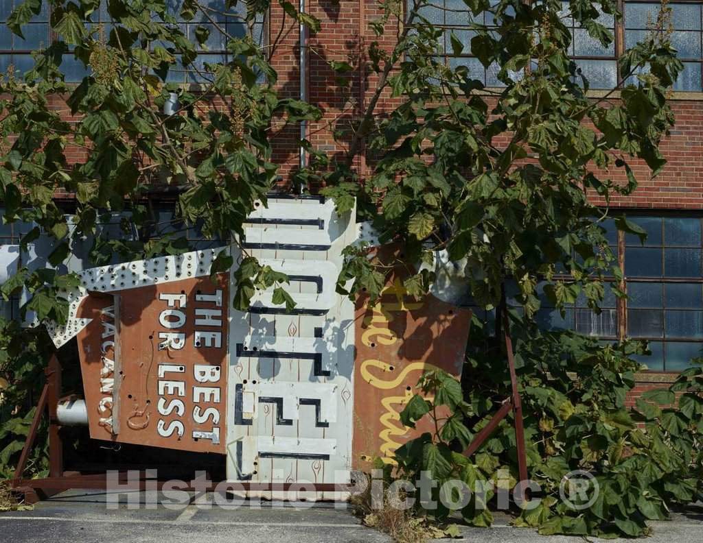 Photograph- Forlorn neon advertising sign, a remnant of an abandoned motel awaiting installation, outside the American Sign Museum in the industrial Camp Washington neighborhood of Cincinnati